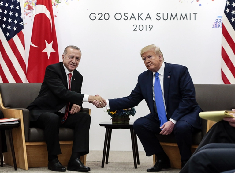 OSAKA, JAPAN - JUNE 29: Turkish President Recep Tayyip Erdogan (L) shakes hand with U.S President Donald Trump (R) as they pose for a photo during their meeting on the second day of the G20 Summit at INTEX Osaka Exhibition Center in Osaka, Japan on June 29, 2019.