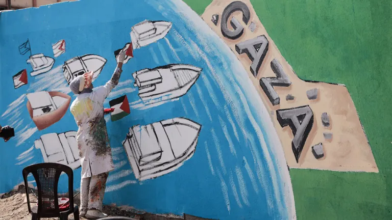 Palestinian artists create graffiti in support of Global Sumud Flotilla in Deir al-Balah