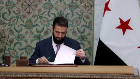 Syrian President Ahmed al-Sharaa signs interim constitutional declaration in Damascus